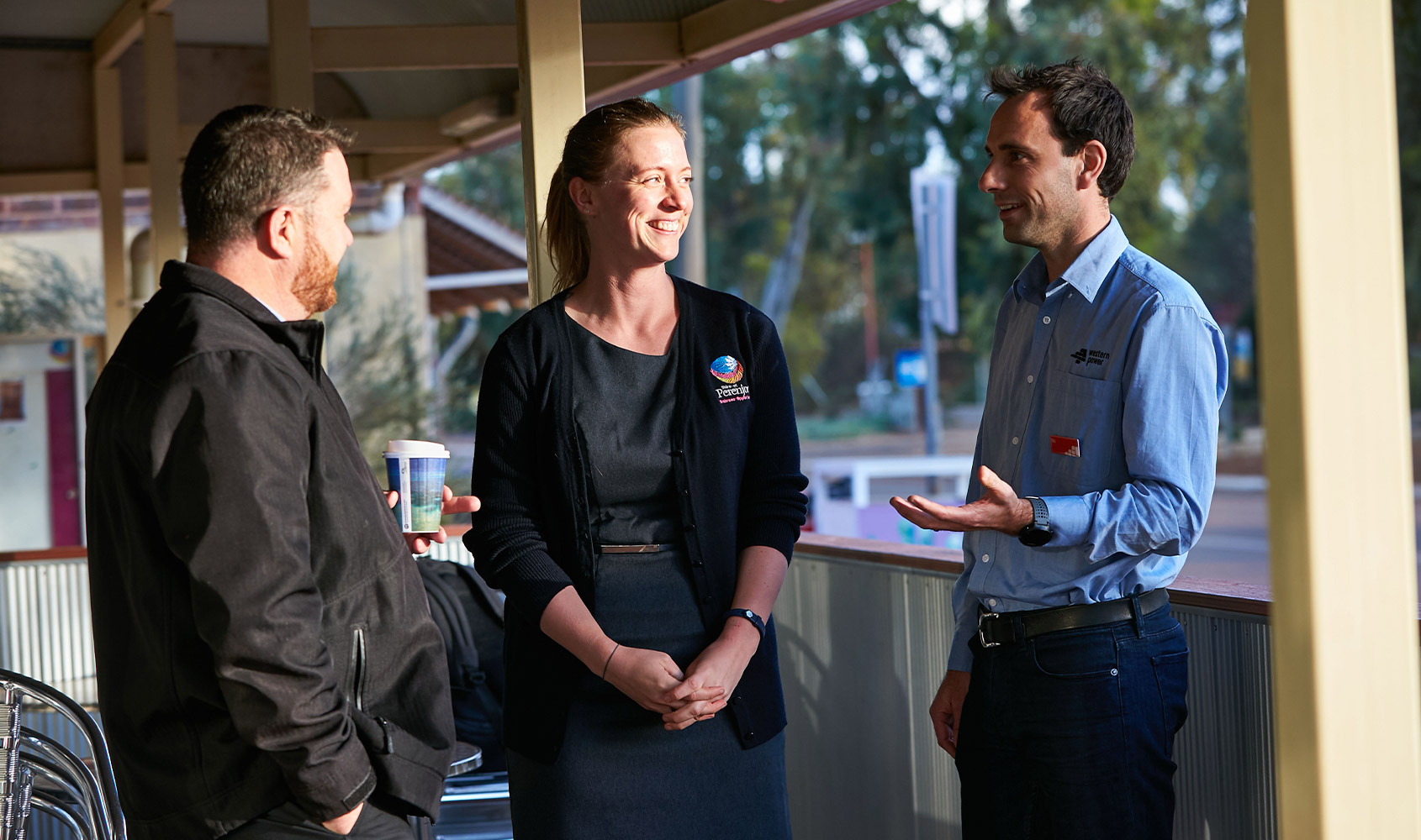 A Western Power employee talking to members of the community