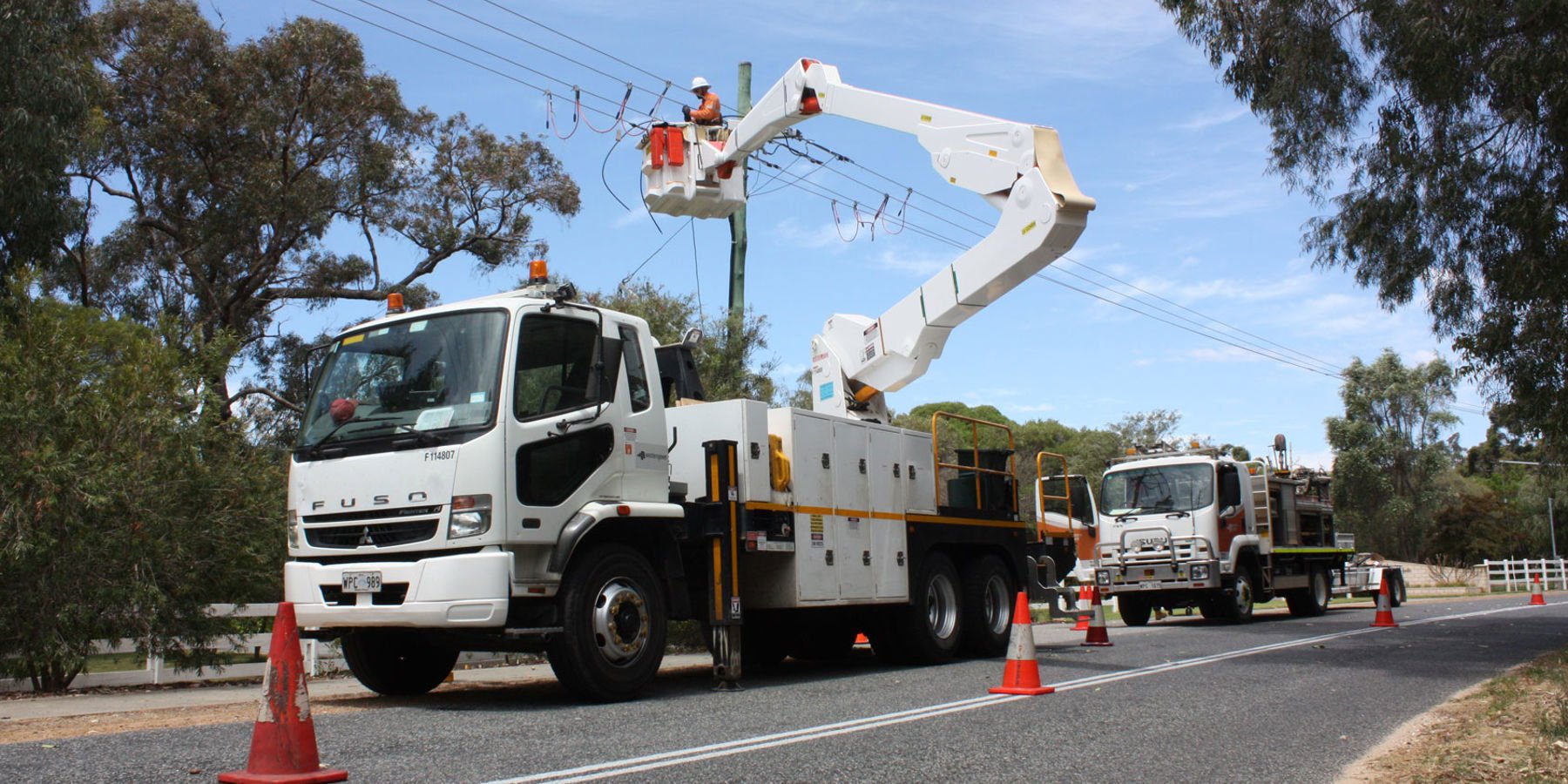 Western Power crew in a cherry picker working on the overhead power lines